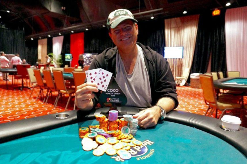 Man with poker cards and chips